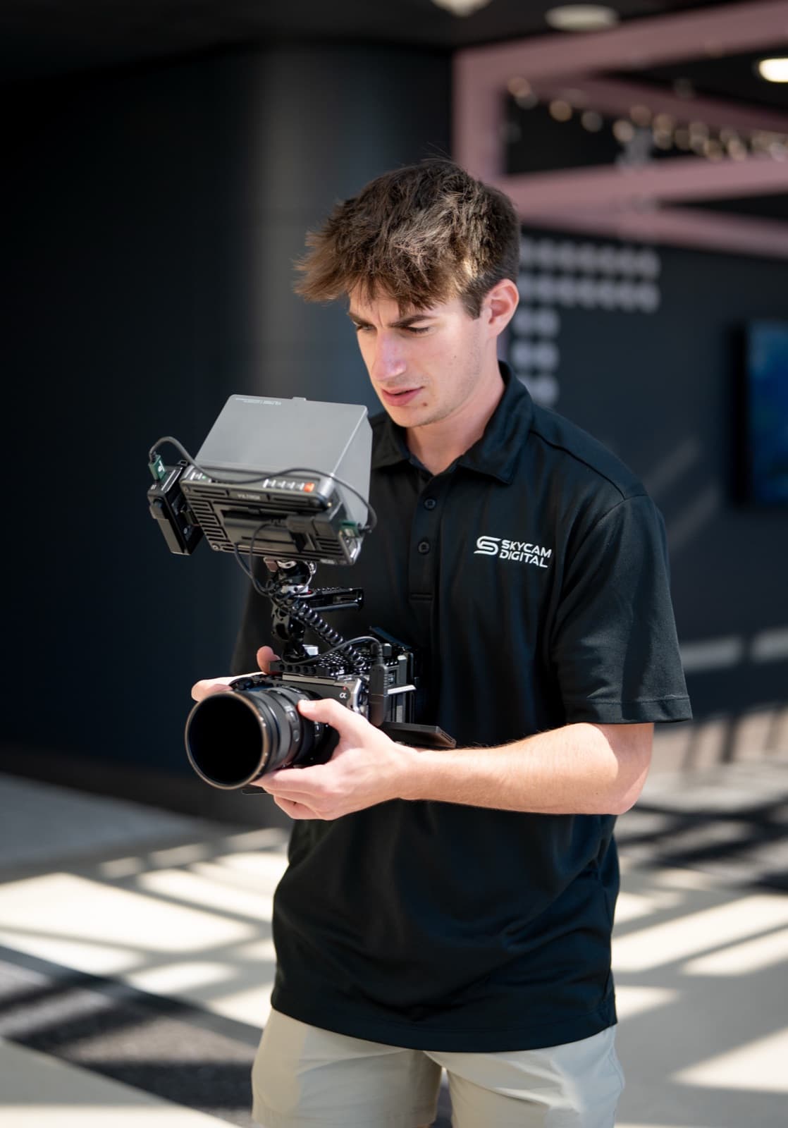 Skycam Digital operator on a commercial set with a field monitor